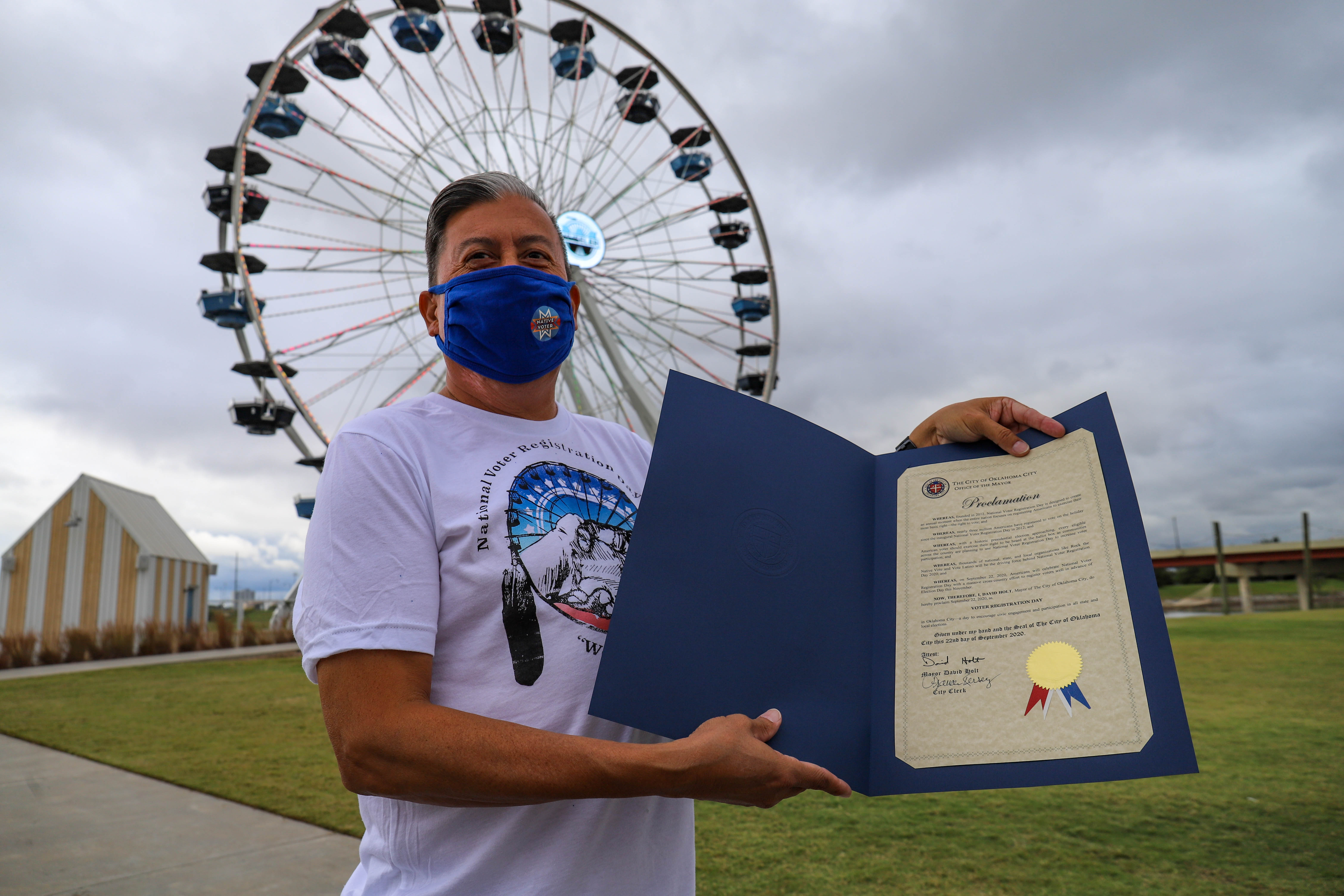 The Rev. David Wilson holds a proclamation by Mayor David Holt declaring Sept. 22 as National Voter Registration Day. 